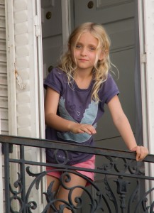 A precious petite fille in the window of her Montmartre apartment