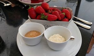 Our dessert which was surprisingly just a container of fresh strawberries with creme freche and brown sugar